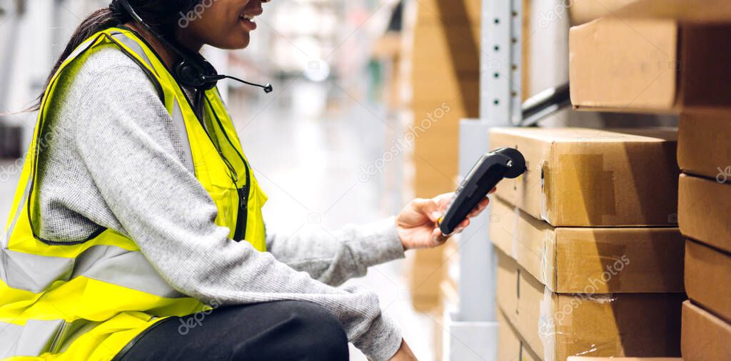 Portrait of african american engineer woman scanning package with barcode scanner check goods in transportation and distribution in warehouse.logistic Industrial and business export