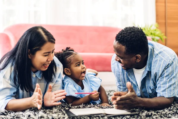 Portrait of enjoy happy love black family african american father and mother with little african girl child smiling and play having fun moments good time in room at home