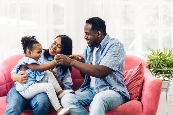 Portrait of enjoy happy love black family african american father and mother with little african girl child smiling and play having fun moments good time in room at home