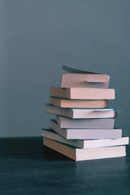 Pile of books ready to be read or that have been read on Book Day  on top of a wooden table