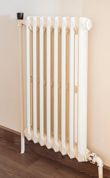 View of old white iron radiator to heat a home in winter.
