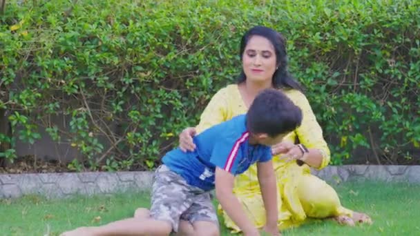 Indian Mother Her Cute Son Child Playing Together Throwing Grasses — Vídeo de Stock
