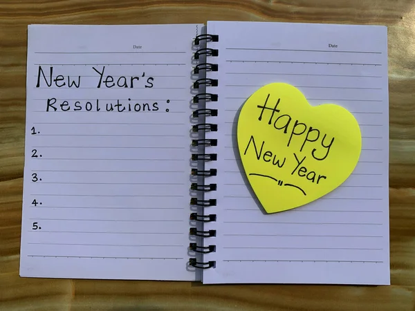 Beautiful wishes on sticky notes with new year resolutions note written on a note pad. — Stockfoto