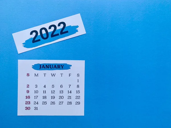 January 2022 white calendar with blue background. 2022 new year concept — Zdjęcie stockowe