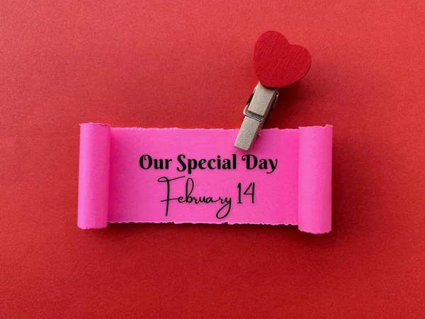 Our special day February 14 text written on a small piece of torn paper with red color background. Valentines Day concept. — Photo
