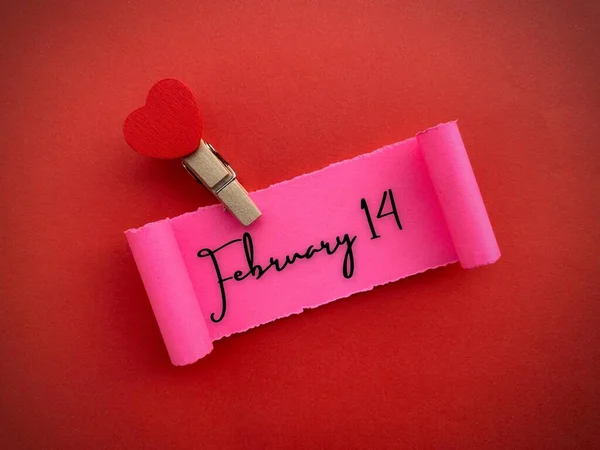 February 14 text on small piece of torn paper with red color background. Valentines Day concept. — Foto de Stock