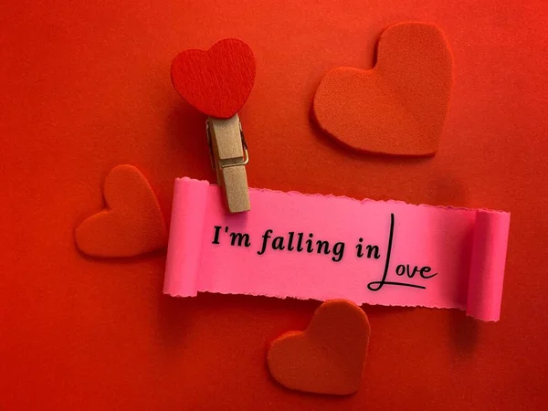 Im falling in love label on torn paper with heart shape and red color background. Valentines Day concept. — стокове фото