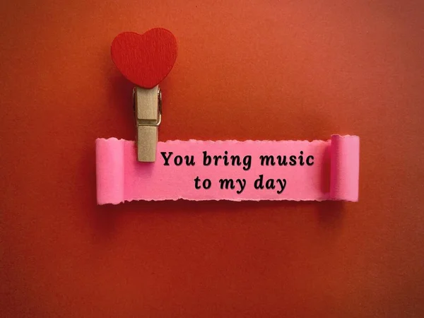 You bring music to my day label on torn paper with red paper background. Valentines Day concept — стокове фото