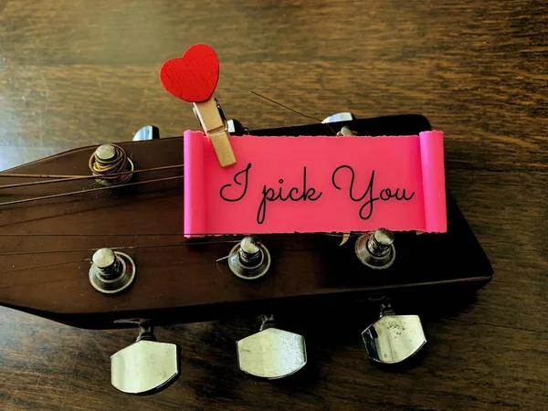 I pick you label on a torn piece of paper with guitar background. Valentines day concept — Photo