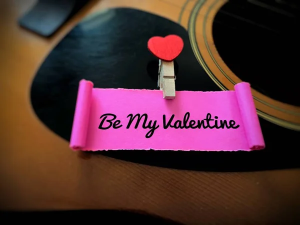 Be my Valentine label on a torn piece of paper with guitar background. Valentines day concept — Foto de Stock