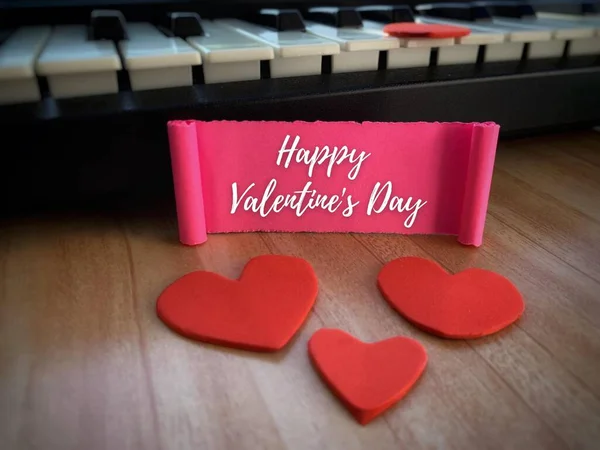 Happy Valentines day label on pink paper with heart shape and keyboard background. — Stockfoto