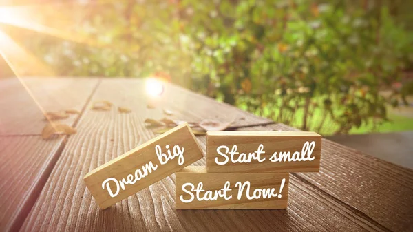 Motivational and Inspirational quote - Dream big, start small and start now text on wooden blocks with bright shining light. Motivational concept. — Stock Photo, Image