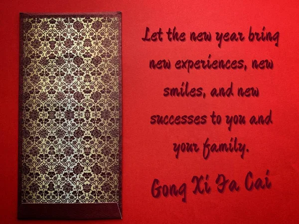 Wonderful Chinese New Year wishes on red cover with dark golden envelope background. Celebration concept.