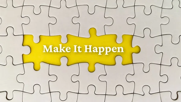 Make it happen text on yellow cover surrounded with missing white puzzle. Business concept