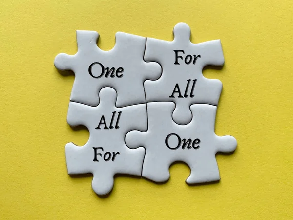 Top view of words on jigsaw puzzle - One for all and all for one. Motivational concept — Stock Photo, Image