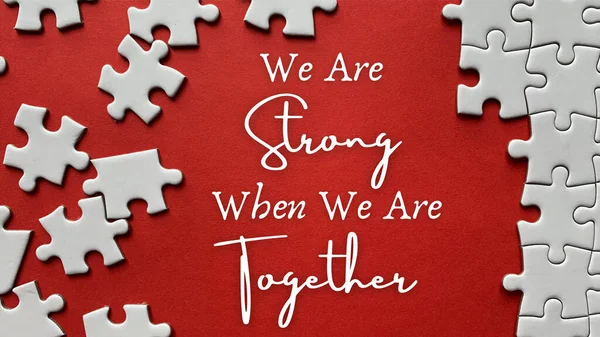 Business motivational quote - We are strong when we are together. On red background of white jigsaw missing pieces. Team work concept. — Stock Photo, Image