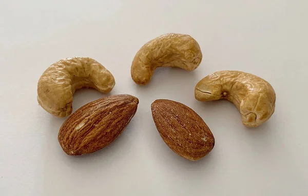 Top view of cashew and almond nuts with white background. — Stock Photo, Image