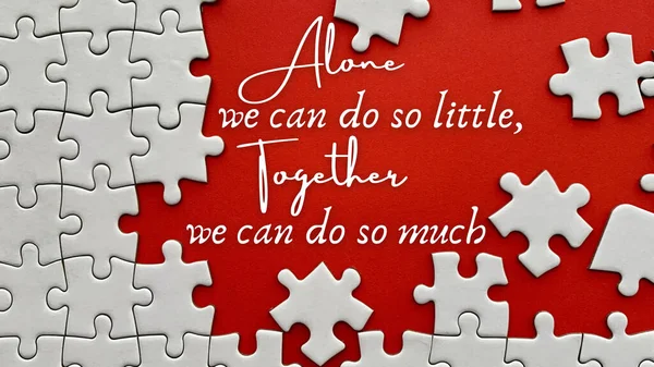 Top view of teamwork inspirational quote on red cover with jigsaw puzzle - Alone we can do so little, together we can do so much. Teamwork concept — Stock Photo, Image
