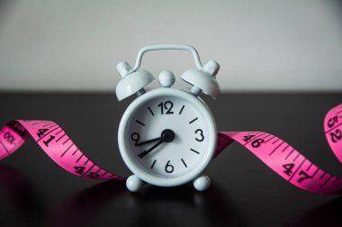 Şerit arka planlı beyaz çalar saat. Fitness konsepti.