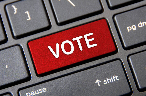 Online voting concept - Laptop keyboard with red Vote button.