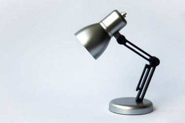 Closeup silver and black small lamp on white color background. Copy space
