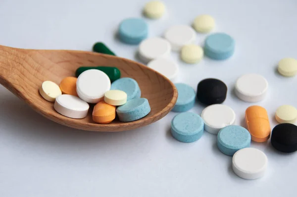 Assorted Pharmaceutical Medicine Pills Tablets Capsules Wooden Spoon Blurred Background — Fotografia de Stock