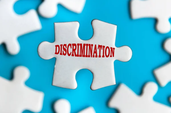 Discrimination Text Jigsaw Puzzle Pieces Isolated Blurred Blue Background — Fotografia de Stock