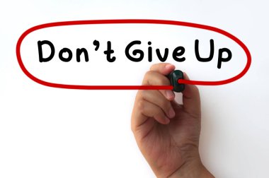 Hand writing circling Don't give up text on transparent wipe board. Motivational concept
