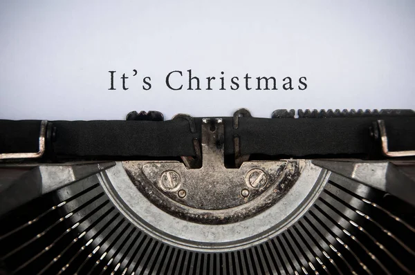 It is Christmas text typed on an old vintage typewriter. Christmas celebration concept