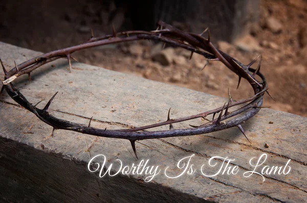 Christian prayer text - Worthy Is The Lamb. With crown of thorns on old wood background. Christianity concept.