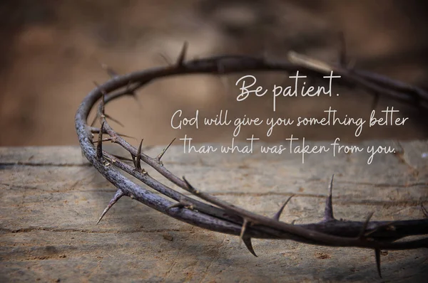 Christian prayer quote - Be patient. God will give you something better that what was taken from you. With crown thorns and old wooden block background.