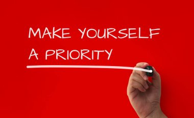 Inspirational quote text on red cover background - Make yourself a priority. Inspirational concept