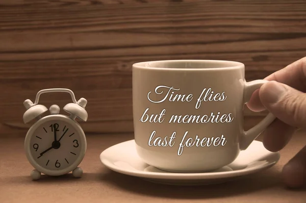 Motivational and inspirational quote - Time flies but memories last forever. With alarm clock and coffee cup background.