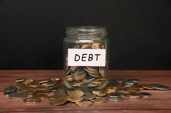 Debt Label Coin Jar Top Wooden Desk Asorted Coins Background — Stockfoto