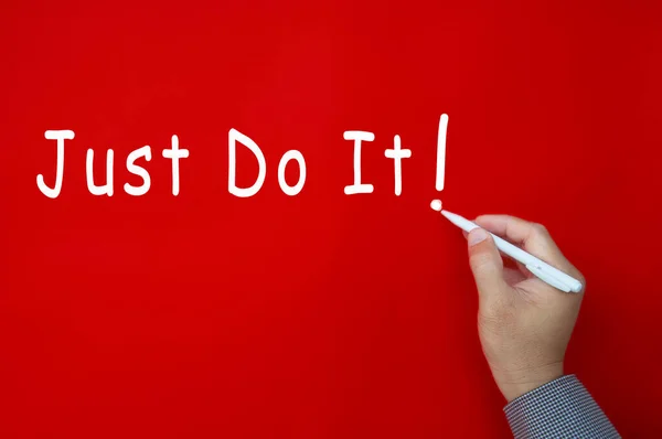 Just do it text written on red cover background. Motivational concept.