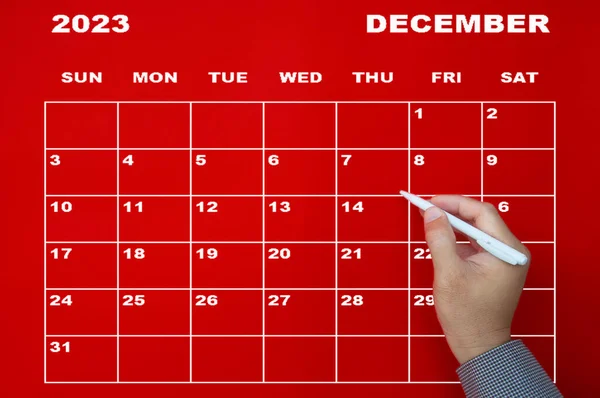 December 2023 Calendar Hand Holding White Pen Red Background Appointment — Stock Photo, Image