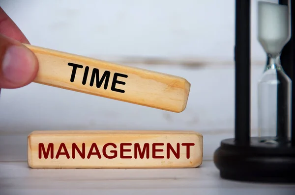 Hand holding wooden blocks with text - Time management. Time management concept