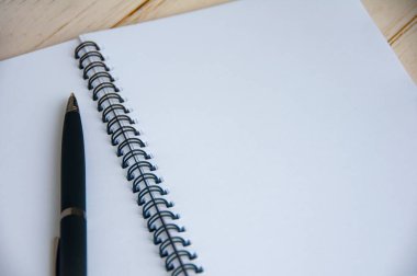 Pen and blank white notepad with space customizable for text or ideas. Copy space