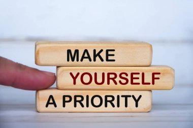 Make yourself a priority text on wooden blocks. Inspirational and motivational concept
