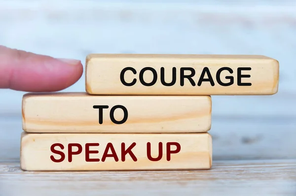 Courage to speak up text on wooden blocks. Business culture concept