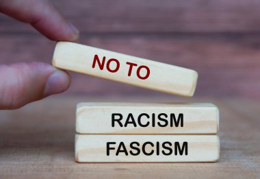Hand holding no to racism and fascism. Rights protection culture concept.