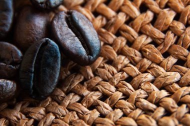 Close up of coffee beans on brown sack with customizable space for text or ideas. Copy space
