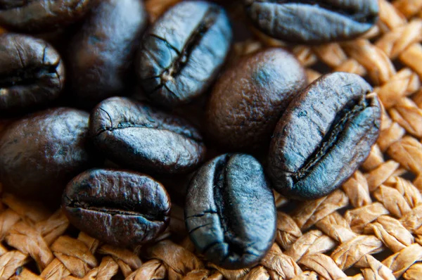 Close up of coffee beans on brown sack. Food and beverage concept