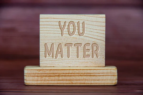 You matter text engraved on wooden block. Inspirational concept.