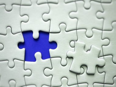 Jigsaw puzzle on blue background with customizable space for text or ideas. Copy space.