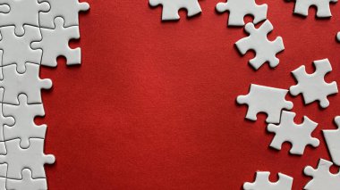 Jigsaw puzzle on red background with customizable space for text or ideas. Copy space.