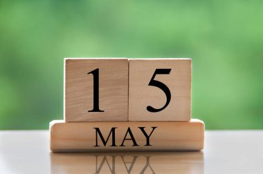 May 15 calendar date text on wooden blocks with blurred nature background. Copy space and calendar concept.
