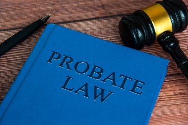 Probate law book with gavel and pen on wooden table. Law concept.