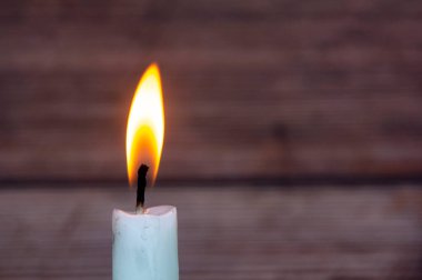 Candle light burning brightly with customizable space for text or ideas. Copy space.
