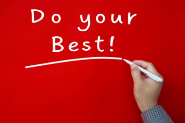 Do your best text written on red cover background. Inspirational concept.